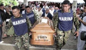 Members of Mexico's navy special forces carry the coffin of their colleague Navy Master Melquisedec Angulo Cordoba at the cemetery in Villahermosa December 21, 2009.